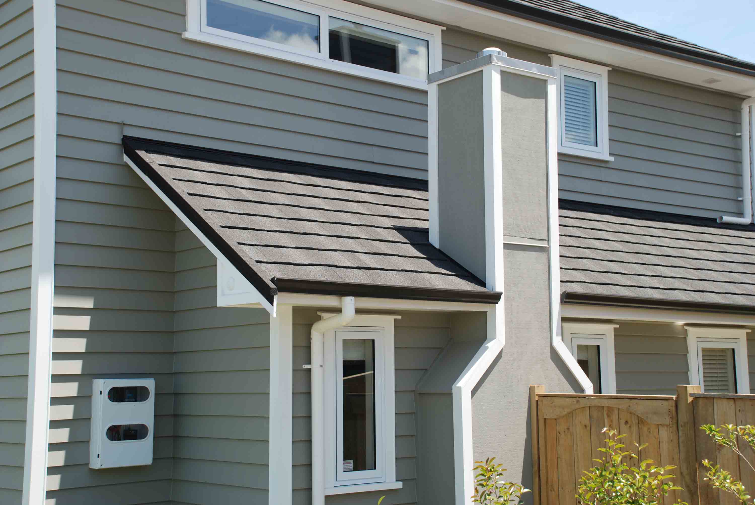 Grey weatherboard home with white joinery, featuring a CF Slate metal roof.