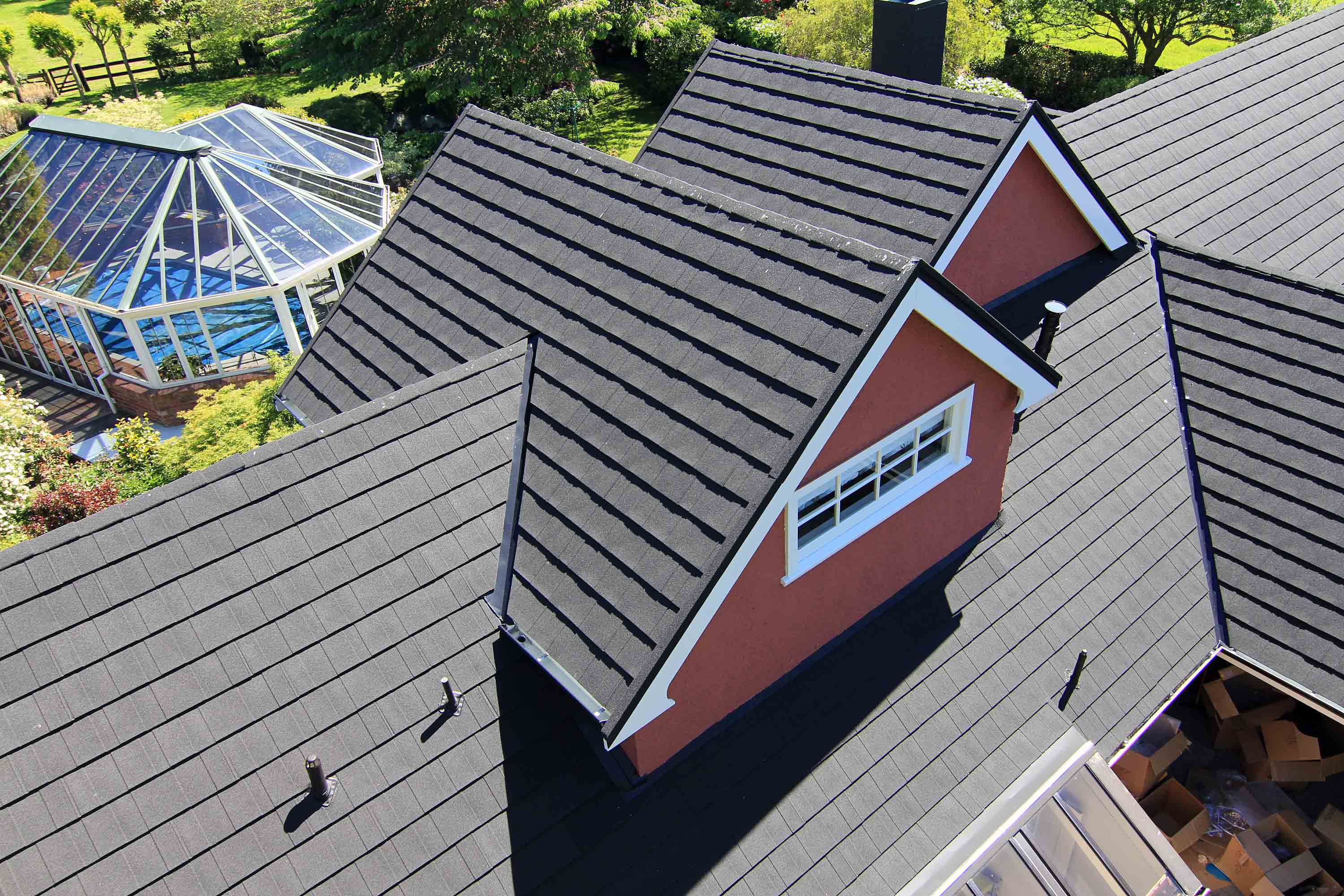 Home re-roofed in CF Slate lightweight metal roofing after being damaged from earthquake. Aerial view.