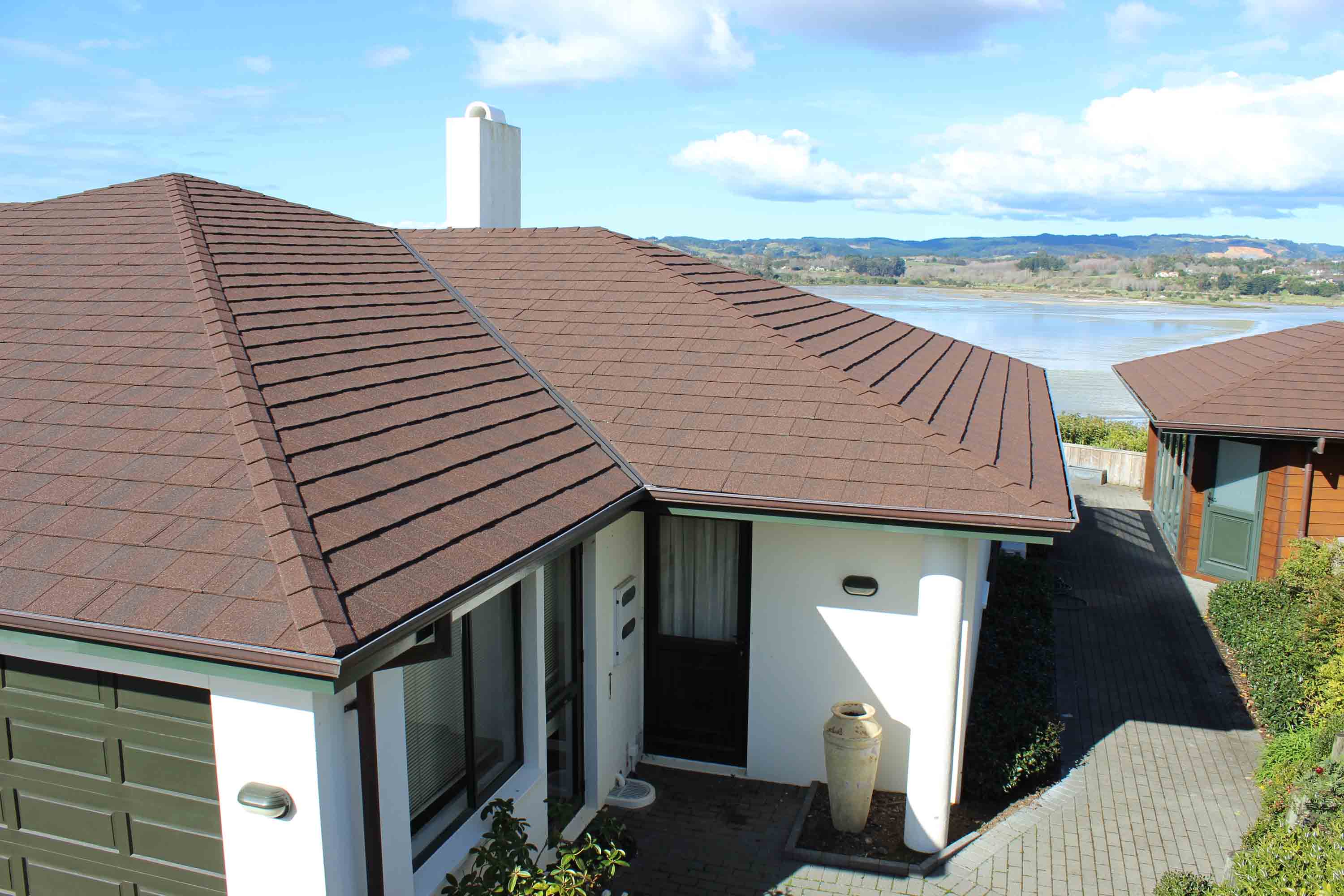 Coastal property roofed with CF Slate metal roof - looking over the roof to the water.