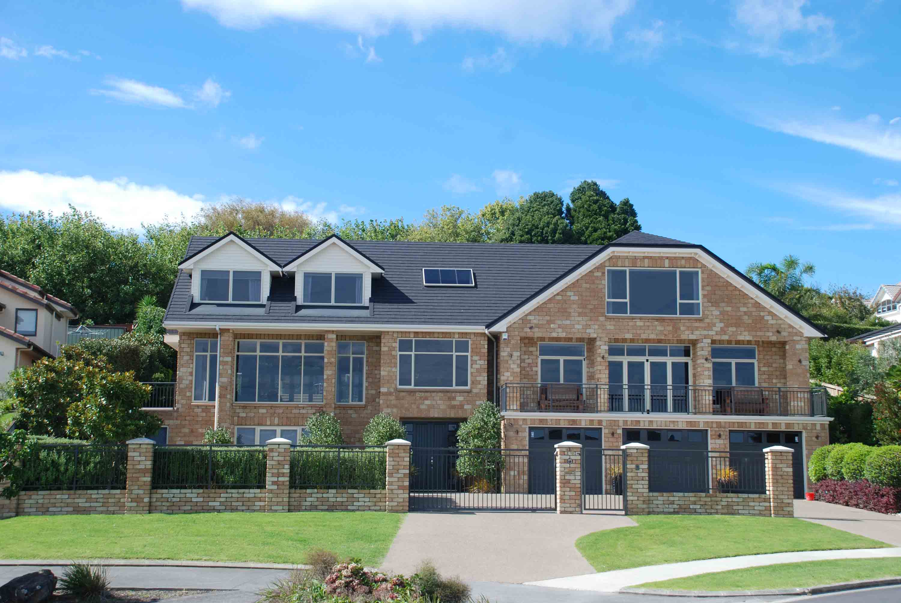 CF Slate, Charcoal metal roof on a brick home viewed from the street